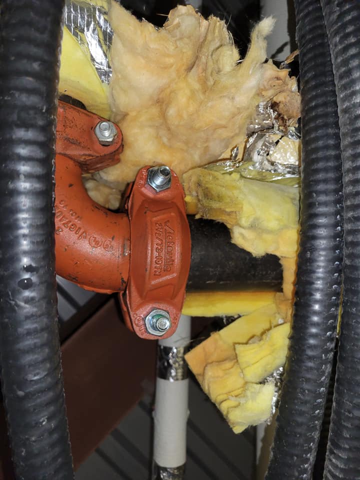 Close-up of pipe coupling and insulation work